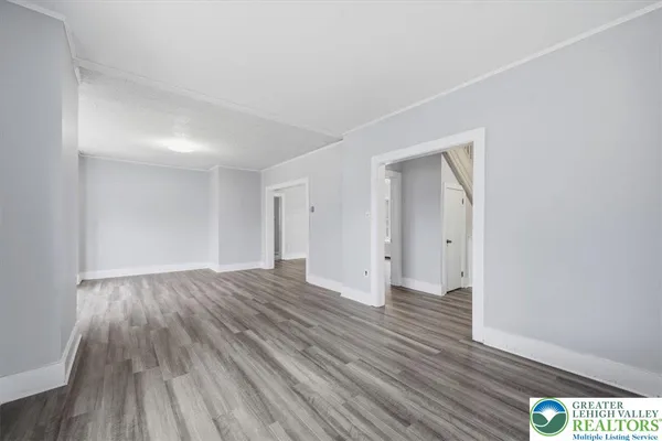 a view of an empty room and wooden floor