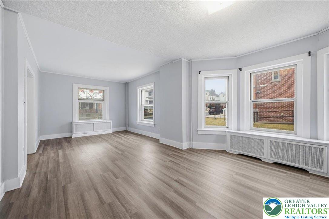 1229 Main Street Northampton, PA 18067 - Photo 10 of 24 an empty room with wooden floor and windows