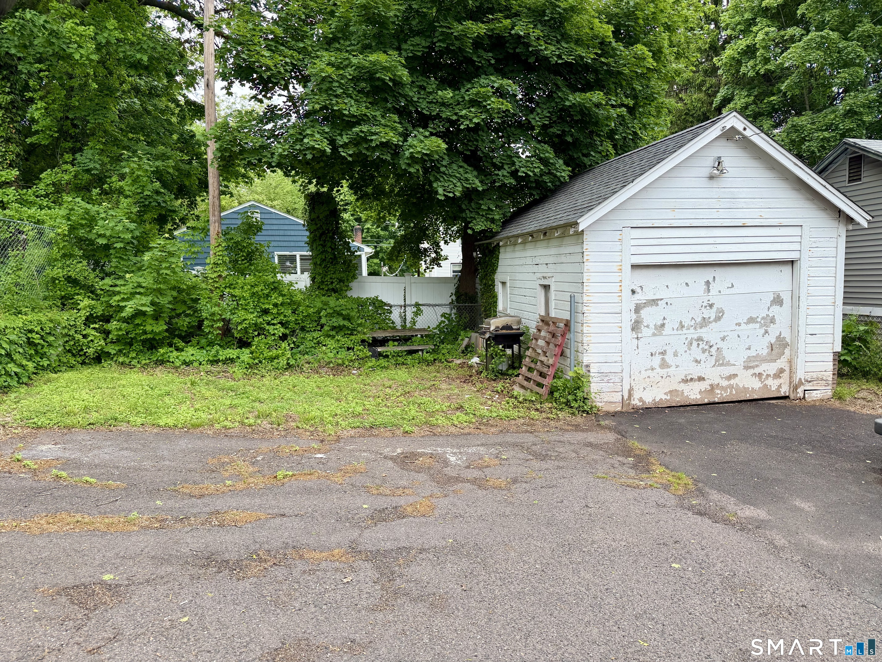 67 Pine Street Meriden, CT 06451 - Photo 32 of 34 a view of a house with a yard and garage