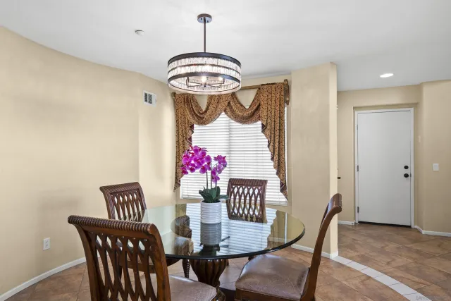 a view of a dining room with furniture and chandelier
