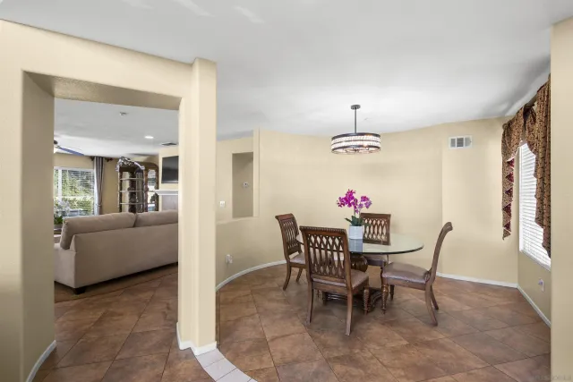 a view of a dining room with furniture and a chandelier