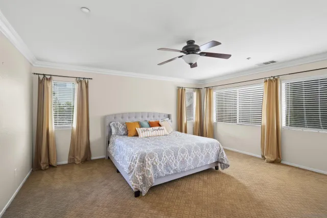 a bedroom with a bed and a television