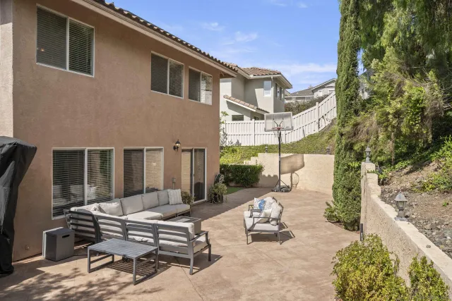 a bench sitting in a backyard next to a building