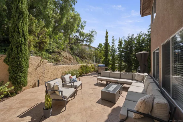 a wooden bench sitting in the middle of a backyard