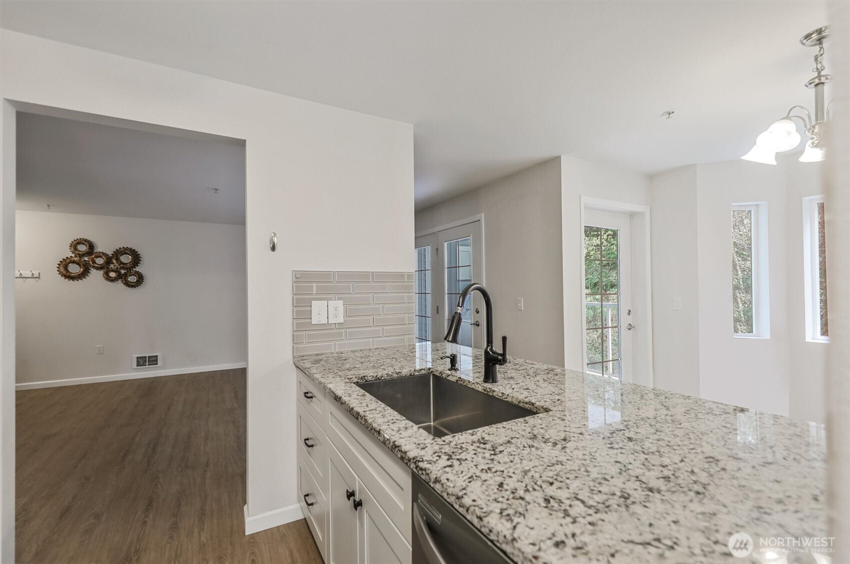 715 Harrington Place Southeast, Unit 2140 Renton, WA 98058 - Photo 17 of 36 a kitchen with granite countertop a sink and a stove