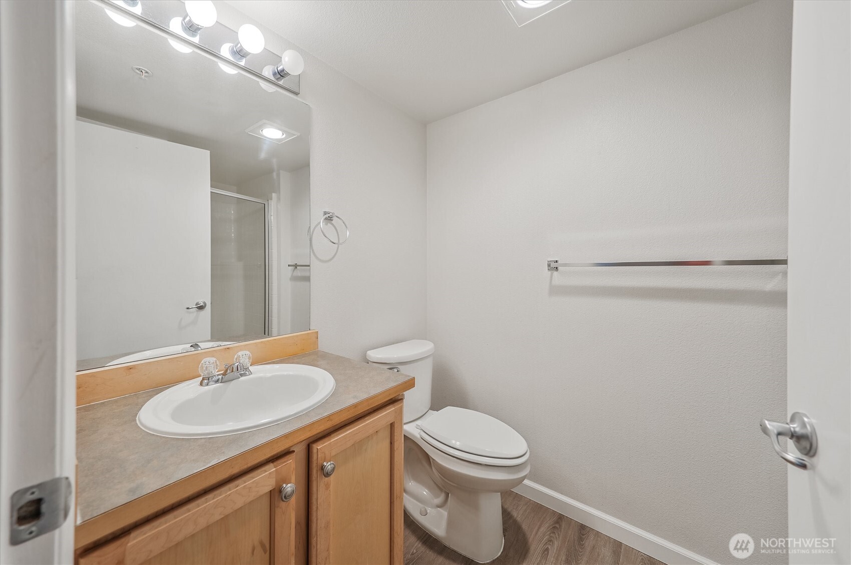 715 Harrington Place Southeast, Unit 2140 Renton, WA 98058 - Photo 21 of 36 a bathroom with a sink toilet and a mirror