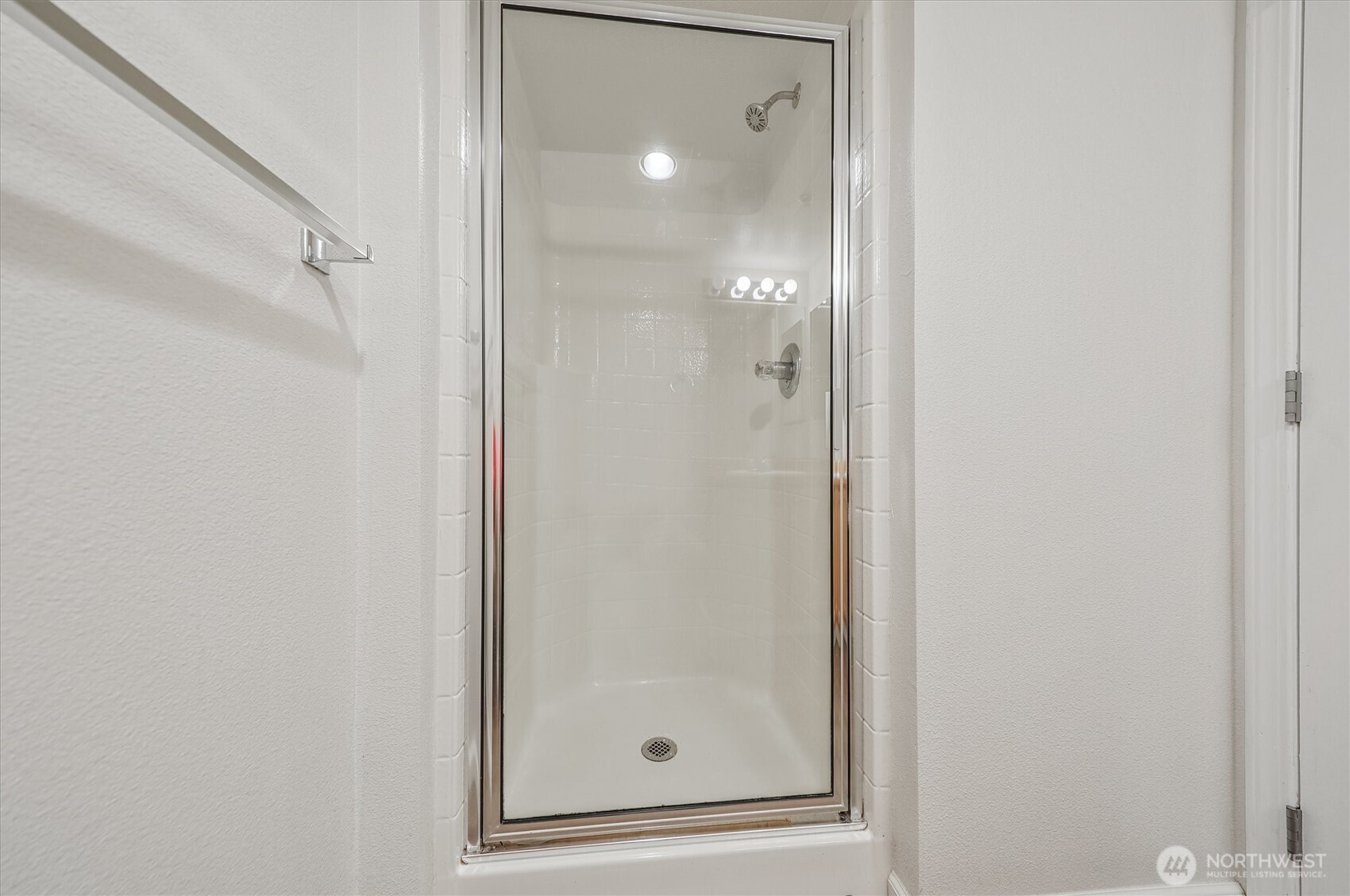 715 Harrington Place Southeast, Unit 2140 Renton, WA 98058 - Photo 23 of 36 a bathroom with a glass shower door and mirror