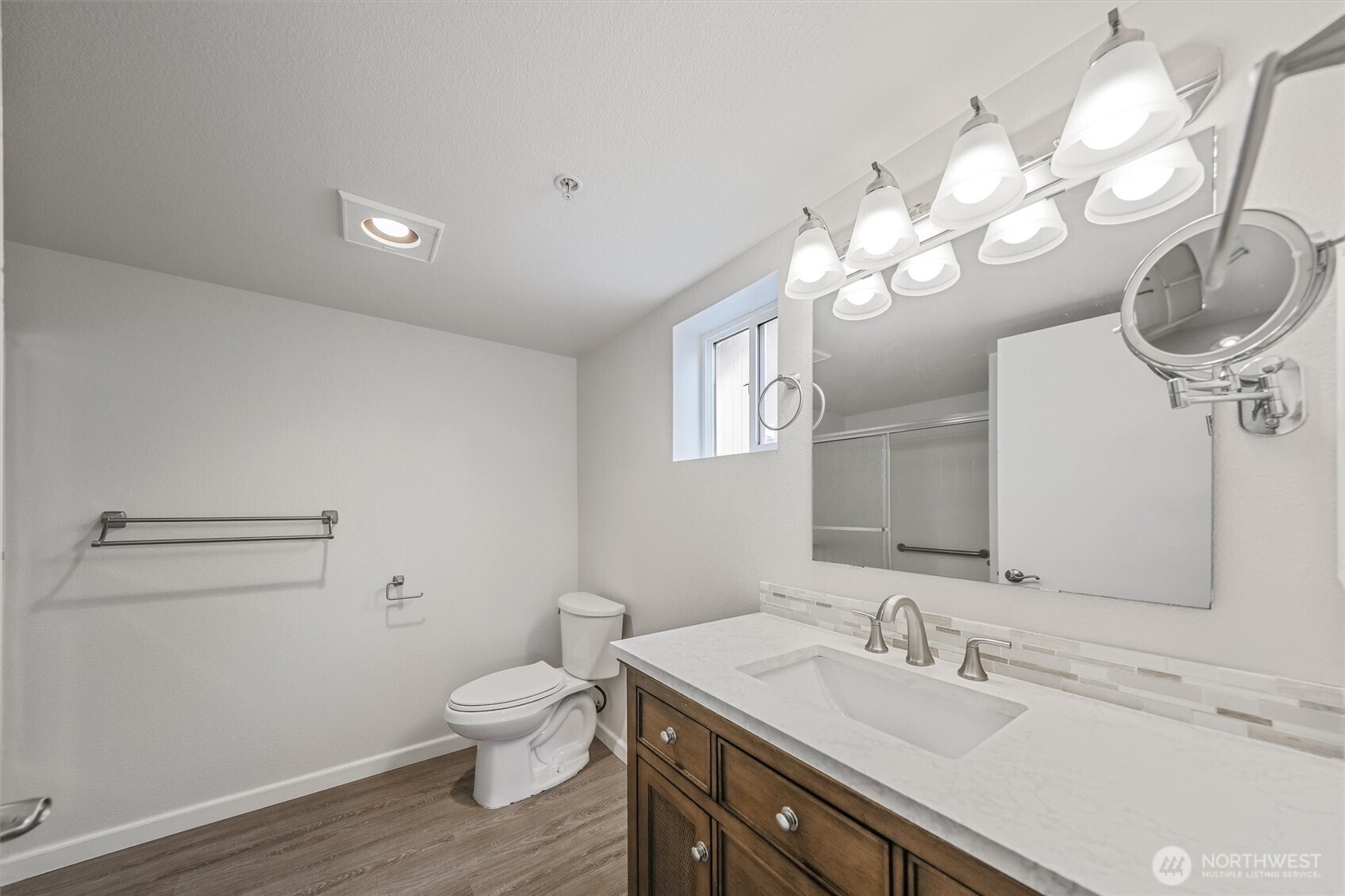 715 Harrington Place Southeast, Unit 2140 Renton, WA 98058 - Photo 26 of 36 a bathroom with a toilet a sink and a mirror