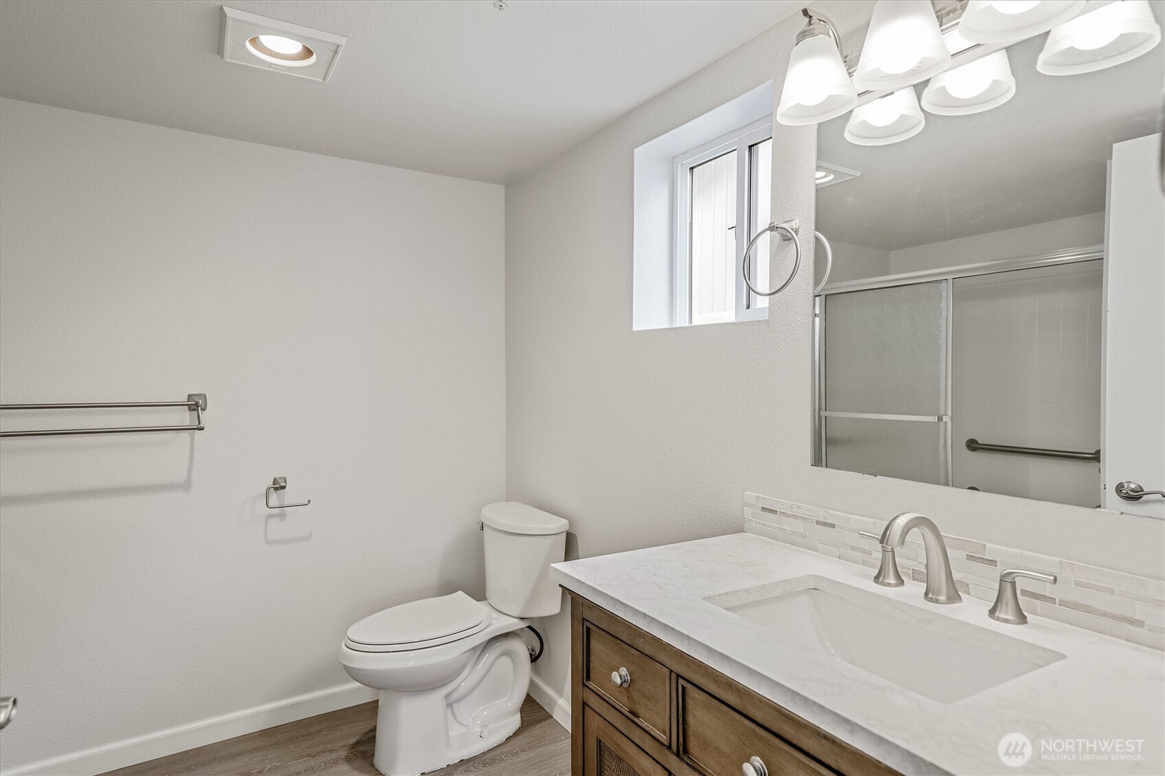 715 Harrington Place Southeast, Unit 2140 Renton, WA 98058 - Photo 27 of 36 a bathroom with a sink a toilet and mirror