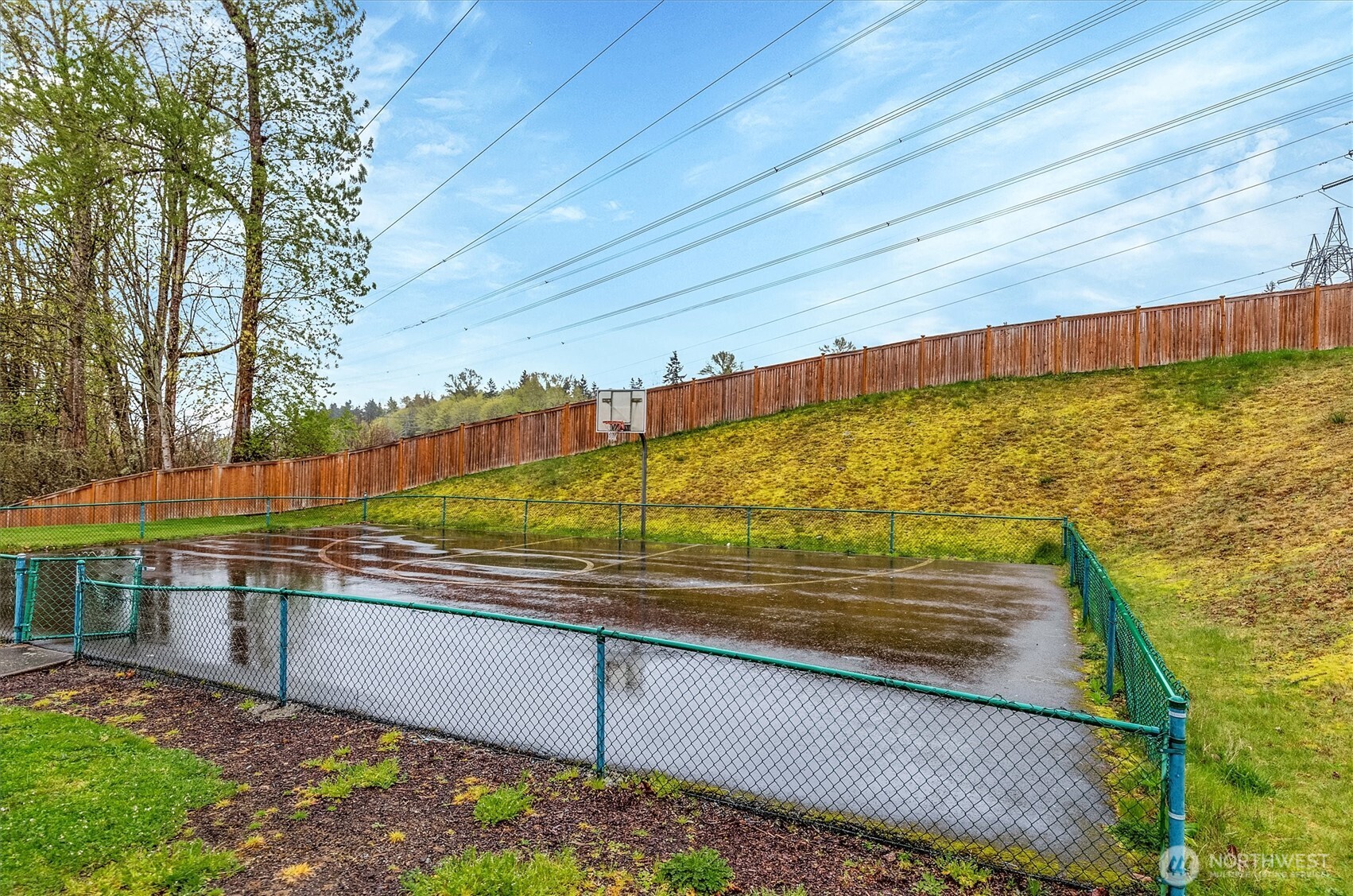 715 Harrington Place Southeast, Unit 2140 Renton, WA 98058 - Photo 34 of 36 a view of a swimming pool with a bench and trees in the background