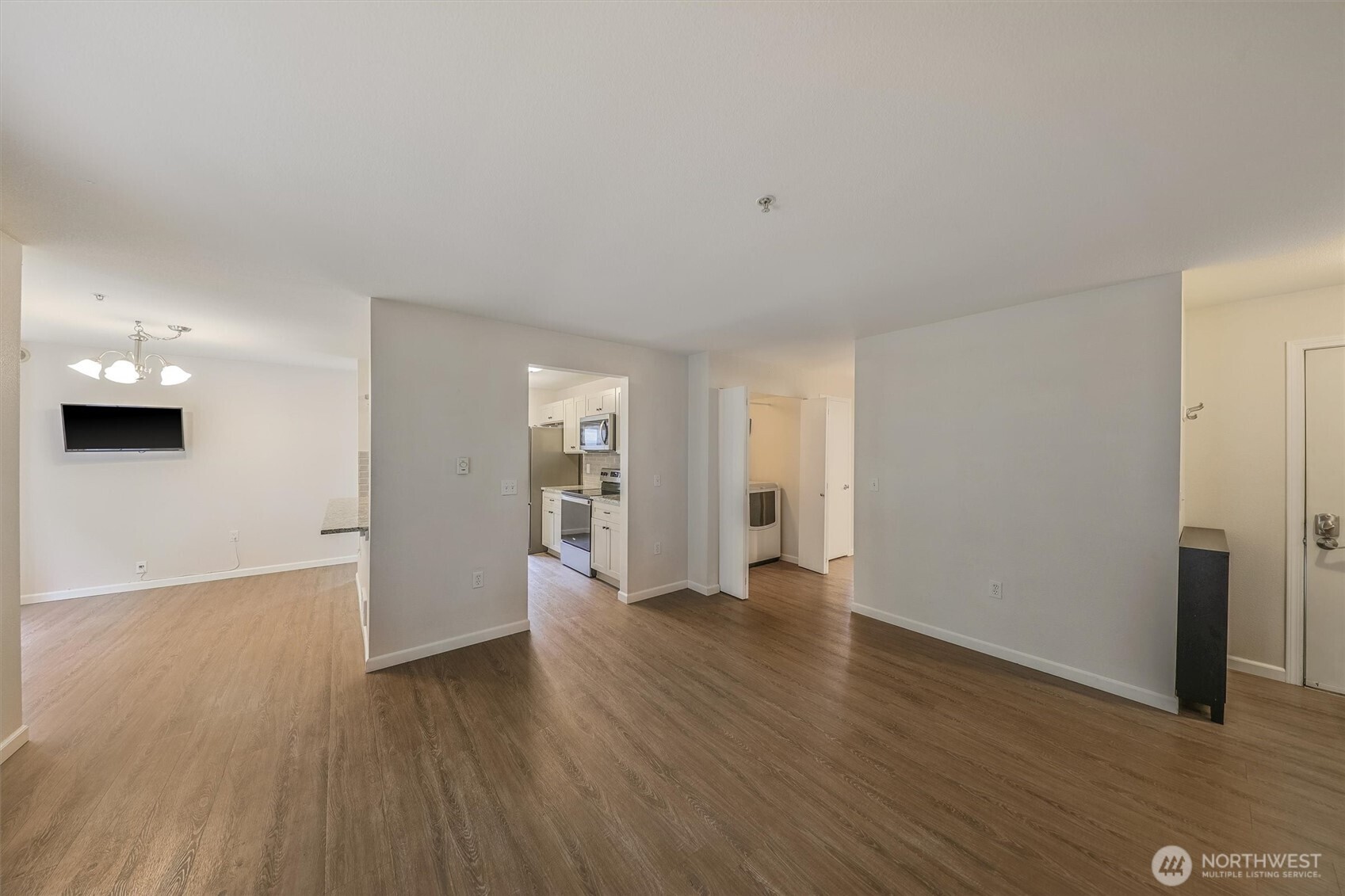 715 Harrington Place Southeast, Unit 2140 Renton, WA 98058 - Photo 7 of 36 a view of an empty room with wooden floor and a window