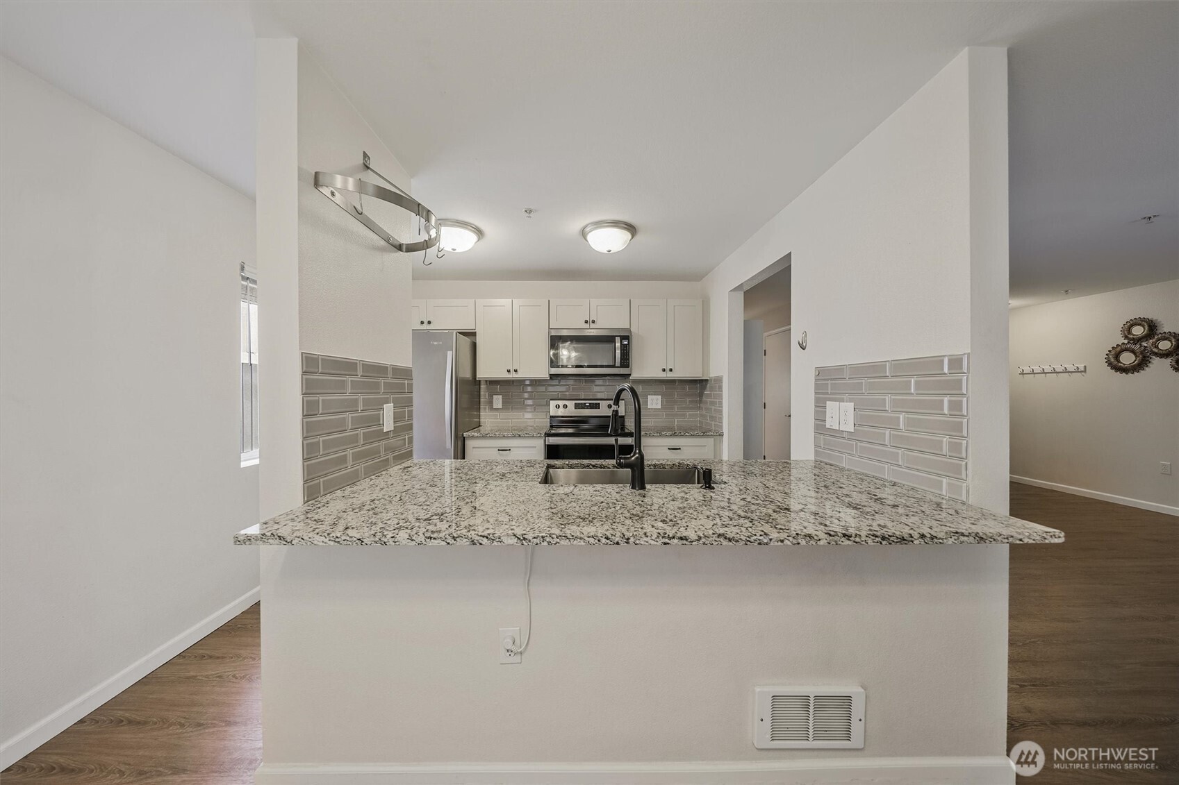 715 Harrington Place Southeast, Unit 2140 Renton, WA 98058 - Photo 10 of 36 a kitchen with stainless steel appliances granite countertop a sink and cabinets