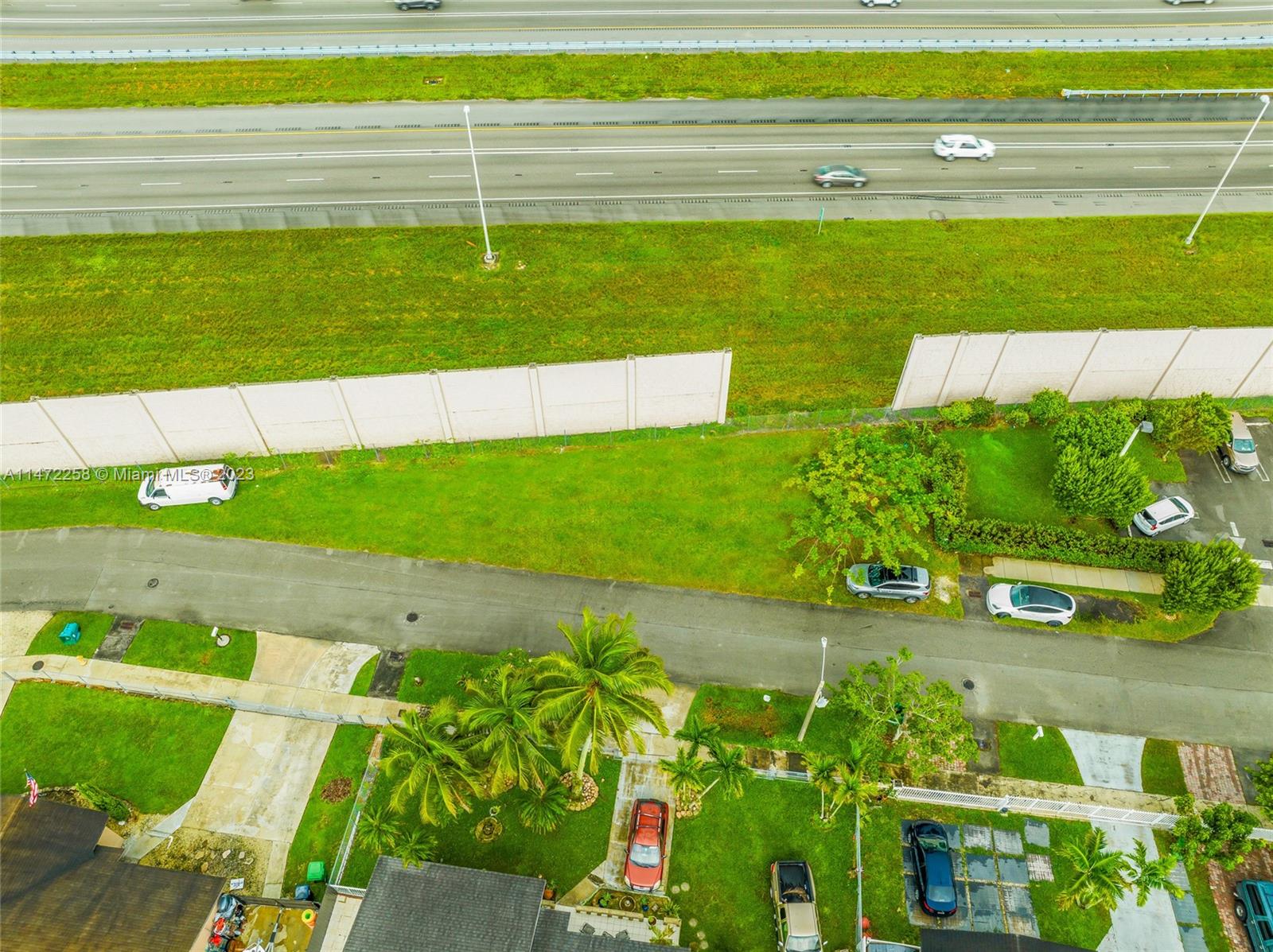 256 Sw Street Homestead, FL 33032 - Photo 6 of 12 a view of a swimming pool with an outdoor space and seating area