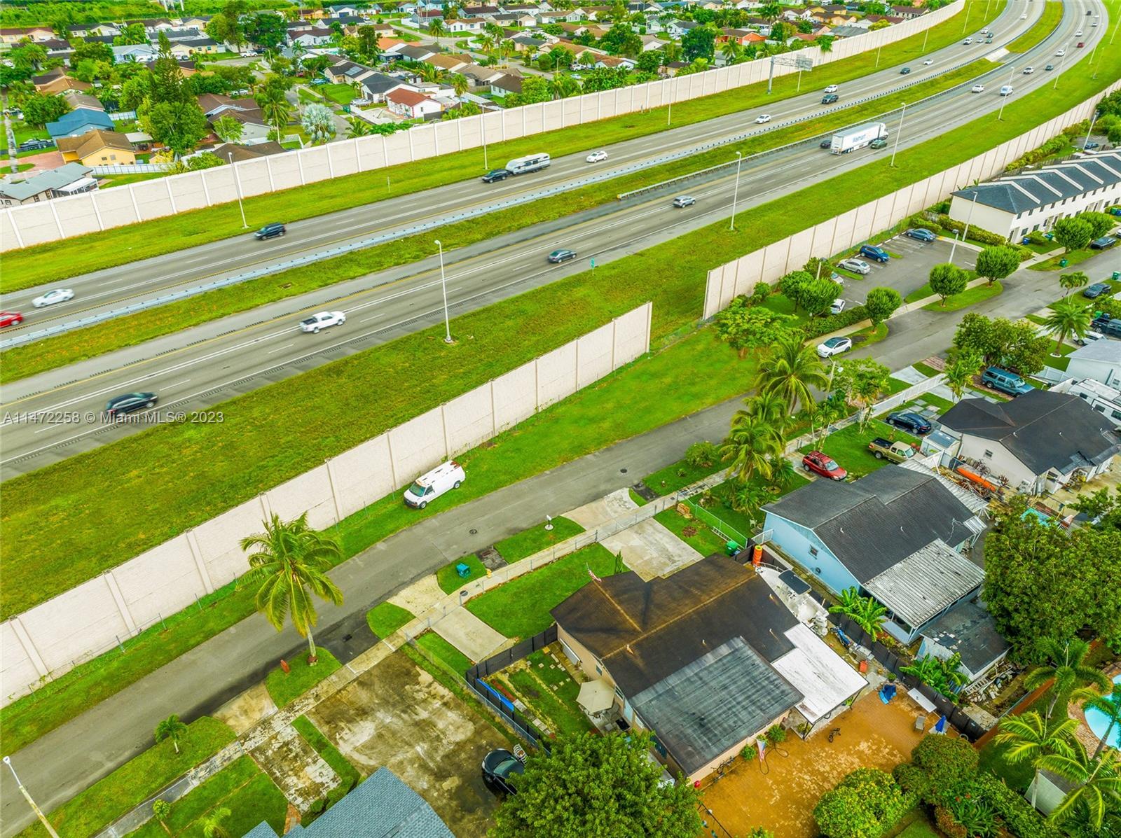 256 Sw Street Homestead, FL 33032 - Photo 10 of 12 a green field with lots of trees in the background