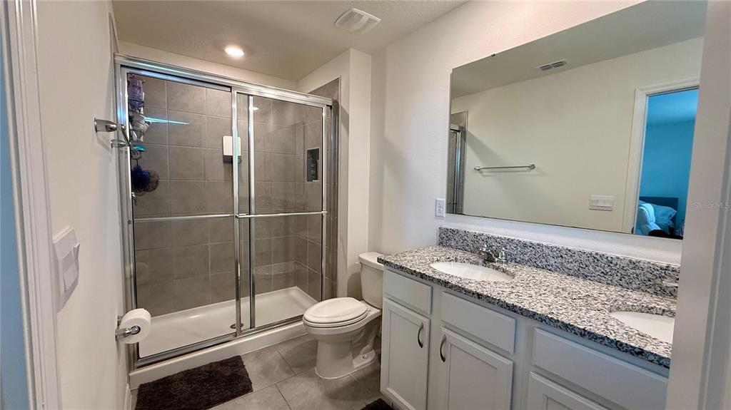 13340 Pontoon Road Winter Garden, FL 34787 - Photo 7 of 15 a bathroom with a granite countertop sink toilet and shower
