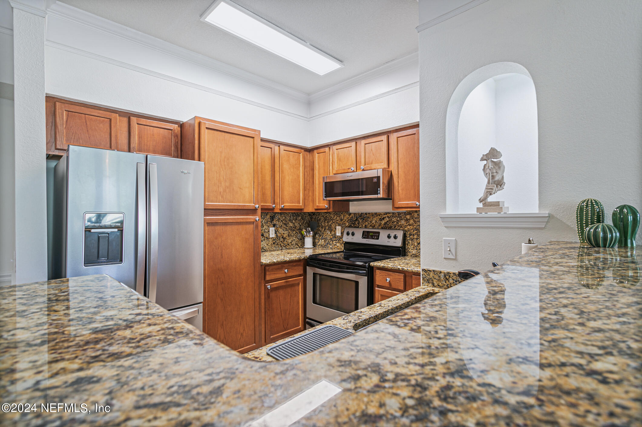 8550 Touchton Road, Unit 927 Jacksonville, FL 32216 - Photo 11 of 59 a kitchen with stainless steel appliances granite countertop a refrigerator stove top oven and sink