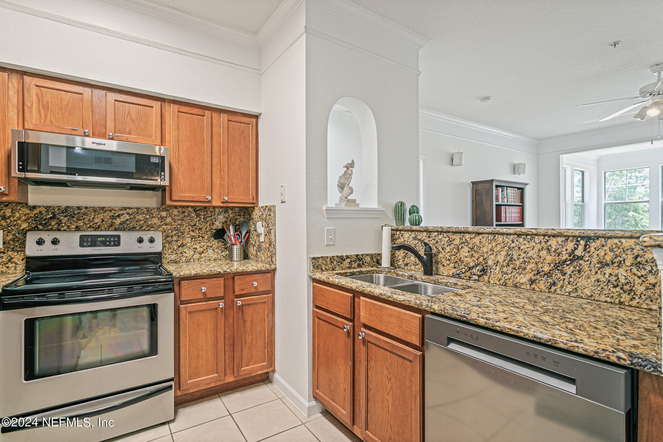 8550 Touchton Road, Unit 927 Jacksonville, FL 32216 - Photo 13 of 59 a kitchen with stainless steel appliances granite countertop a stove microwave and cabinets