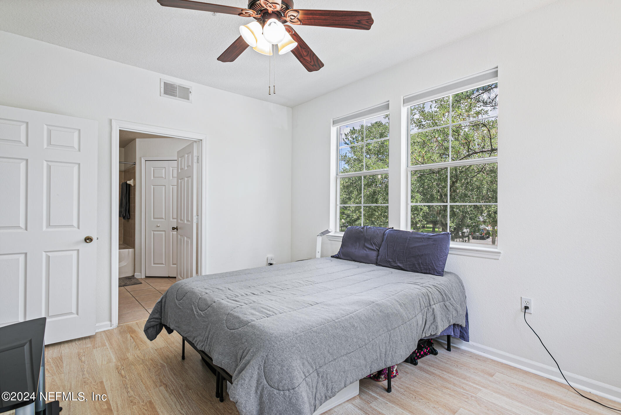 8550 Touchton Road, Unit 927 Jacksonville, FL 32216 - Photo 22 of 59 a bedroom with a bed and wooden floor