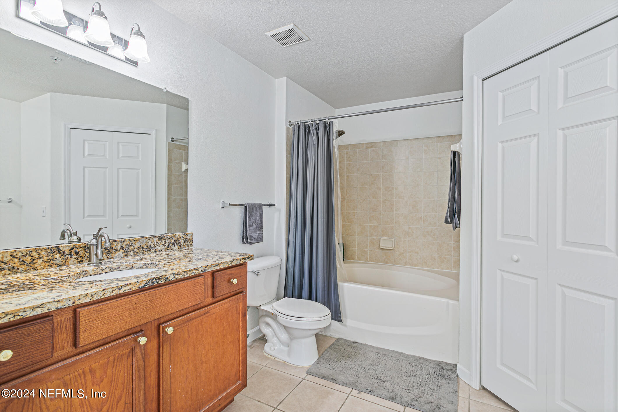 8550 Touchton Road, Unit 927 Jacksonville, FL 32216 - Photo 23 of 59 a bathroom with a granite countertop sink toilet and shower