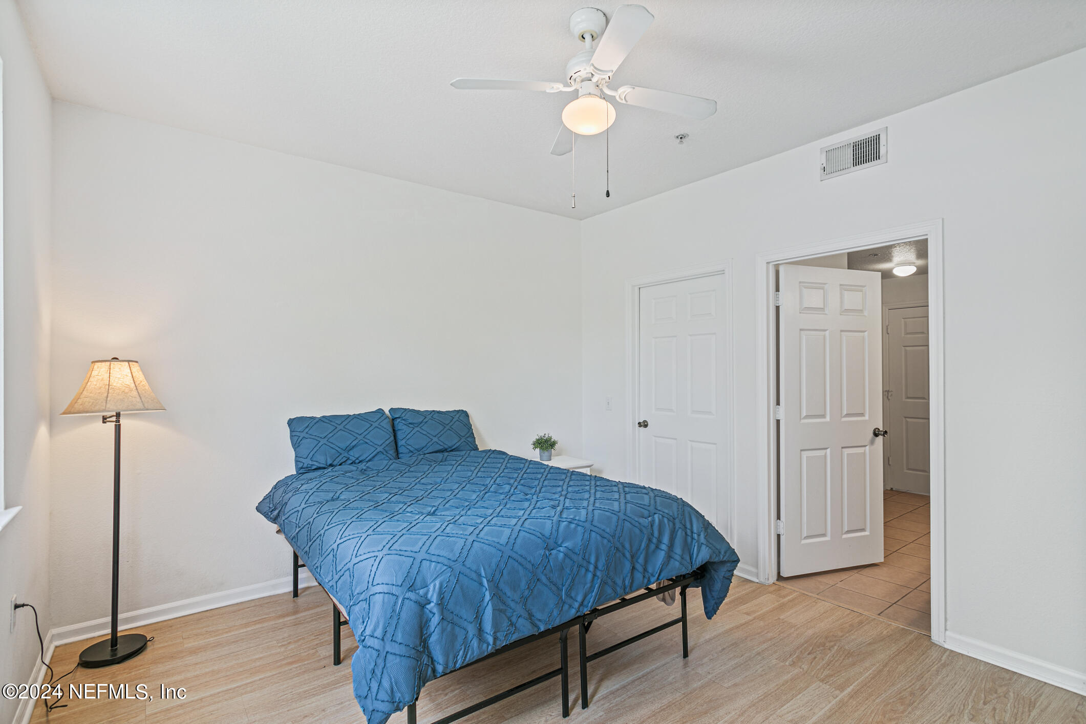 8550 Touchton Road, Unit 927 Jacksonville, FL 32216 - Photo 26 of 59 a spacious bedroom with a bed and a chandelier