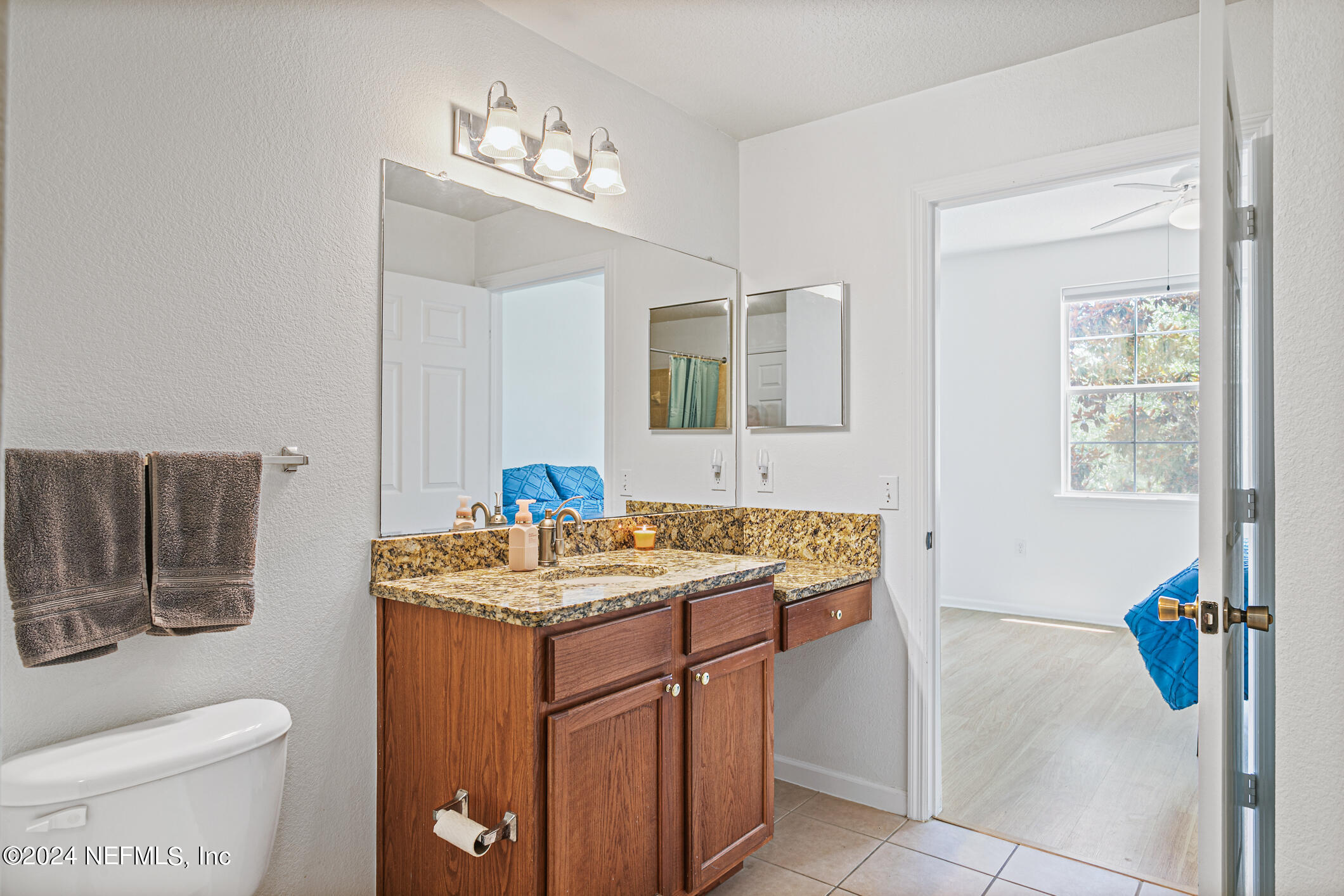 8550 Touchton Road, Unit 927 Jacksonville, FL 32216 - Photo 27 of 59 a bathroom with a sink toilet vanity and mirror