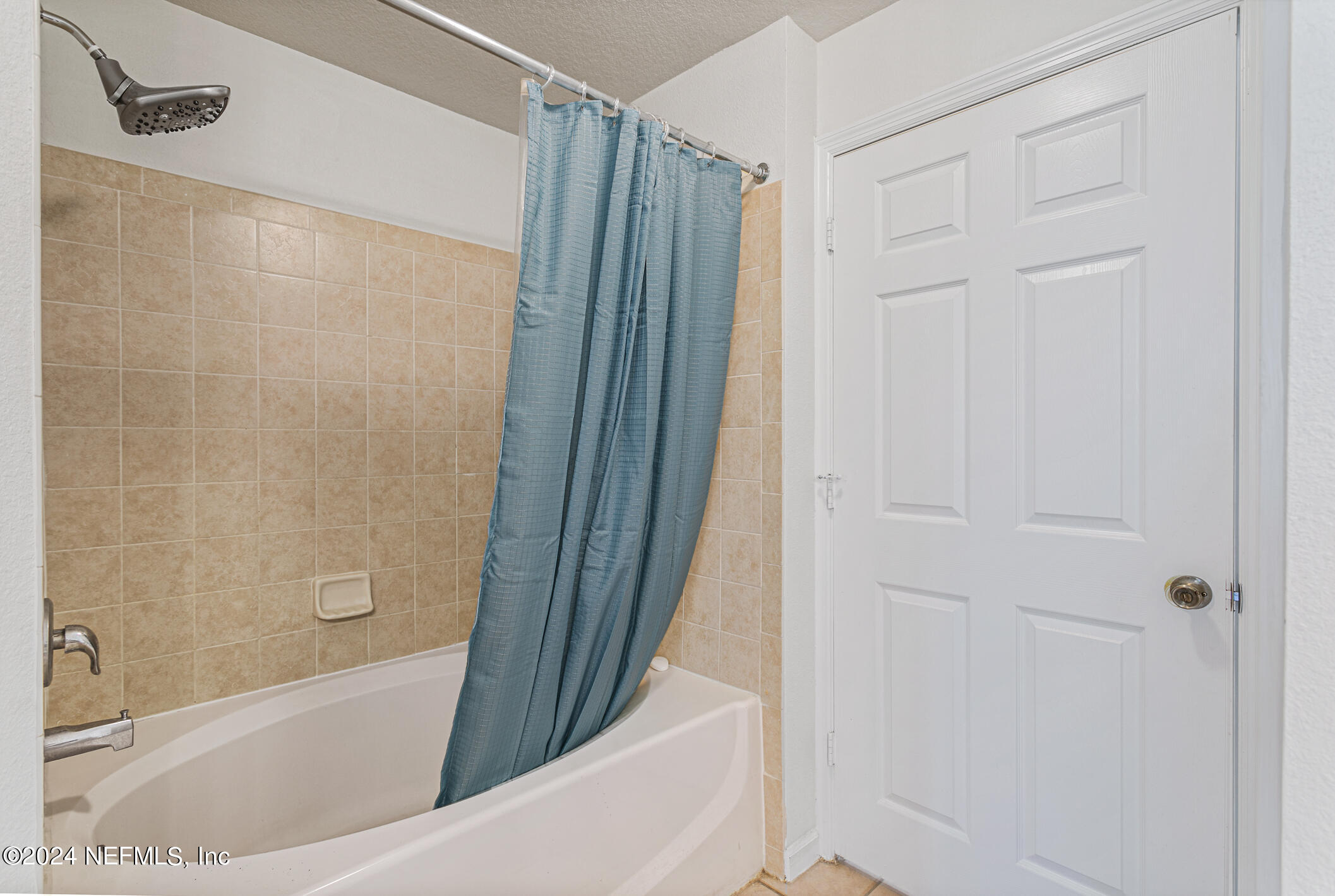 8550 Touchton Road, Unit 927 Jacksonville, FL 32216 - Photo 28 of 59 a bathroom with a bathtub and a shower