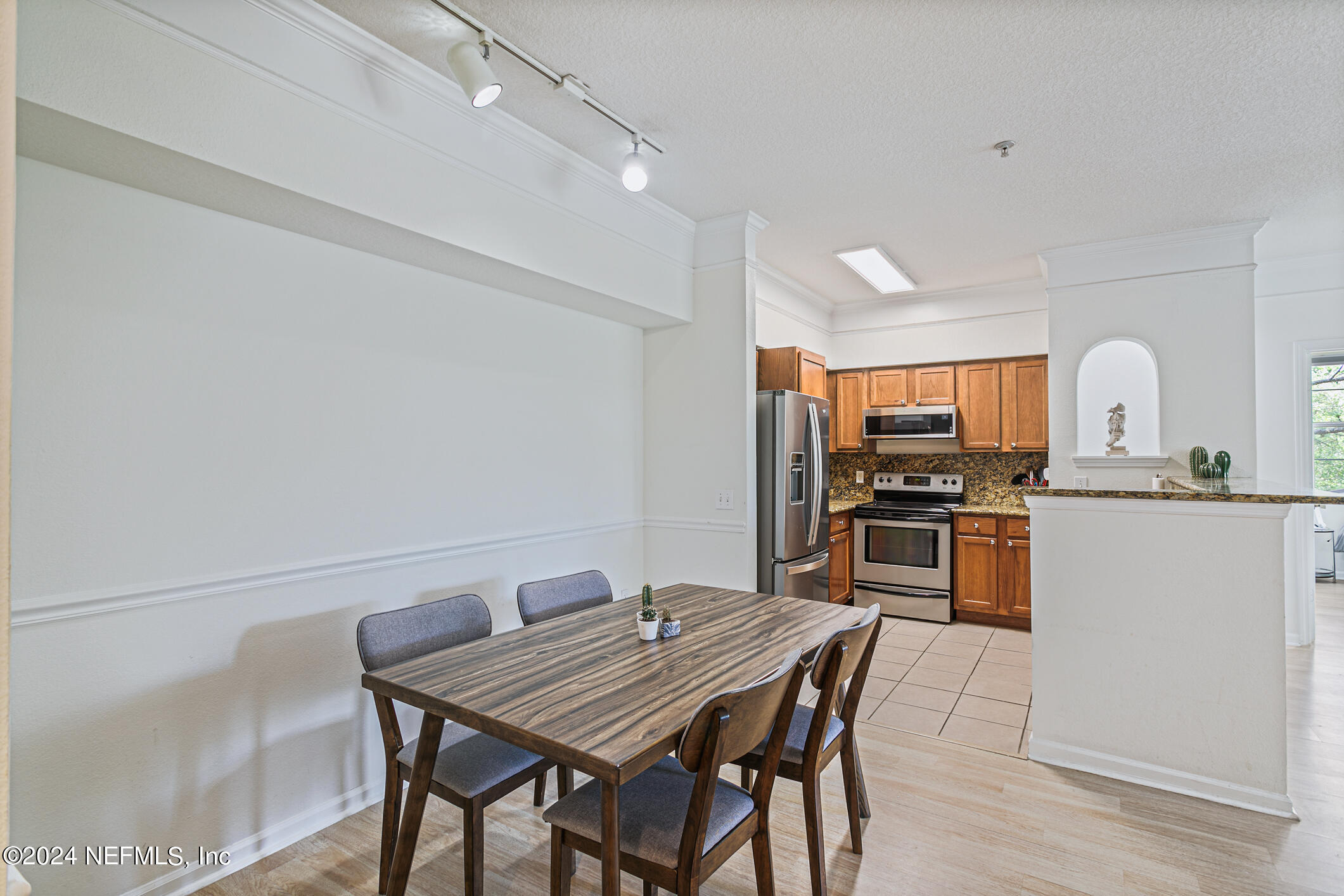 8550 Touchton Road, Unit 927 Jacksonville, FL 32216 - Photo 7 of 59 a kitchen with stainless steel appliances kitchen island granite countertop a kitchen island a stove a table and chairs