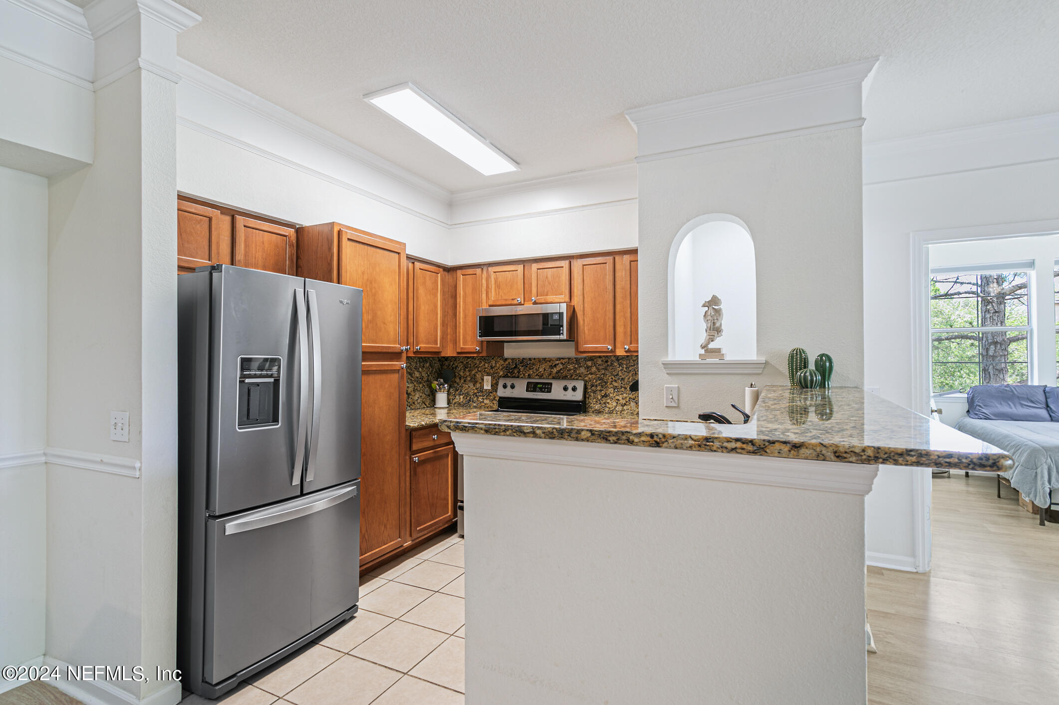 8550 Touchton Road, Unit 927 Jacksonville, FL 32216 - Photo 10 of 59 a kitchen with stainless steel appliances granite countertop a refrigerator a stove and a sink