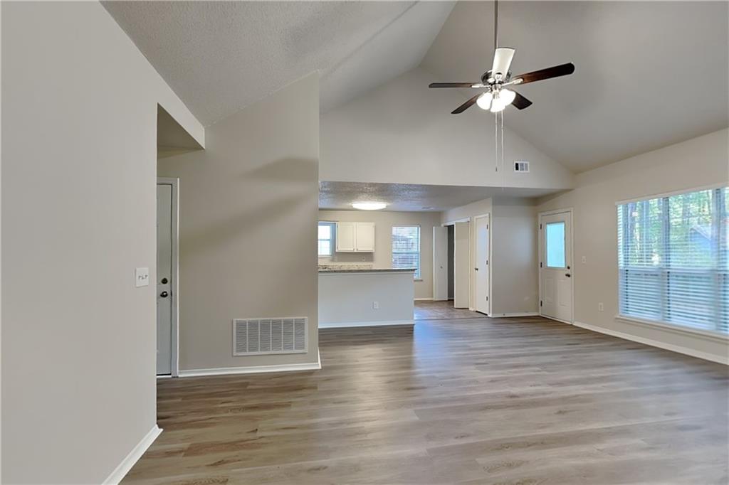 3979 Sharon Spring Powder Springs, GA 30127 - Photo 4 of 18 an empty room with wooden floor chandelier and windows