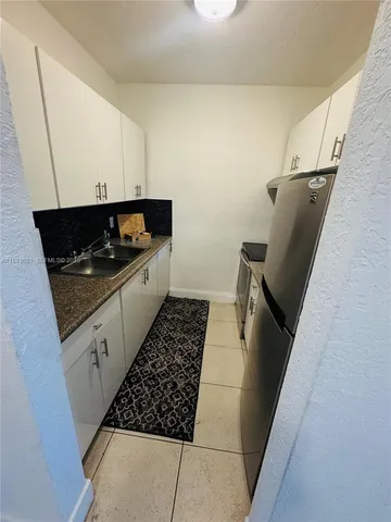 a kitchen with granite countertop a stove and a refrigerator