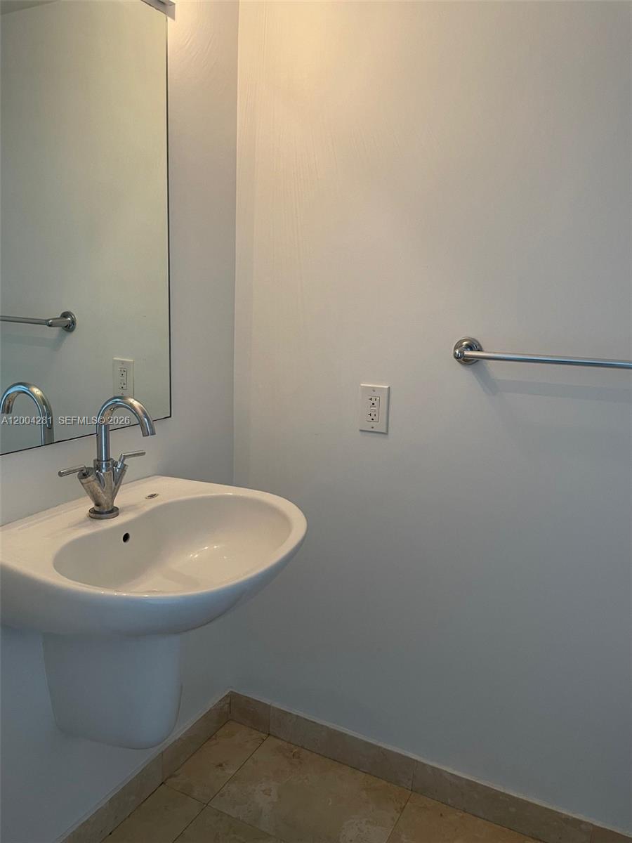 41 Southeast 5th Street, Unit 1614 Miami, FL 33131 - Photo 14 of 23 a bathroom with a sink and mirror