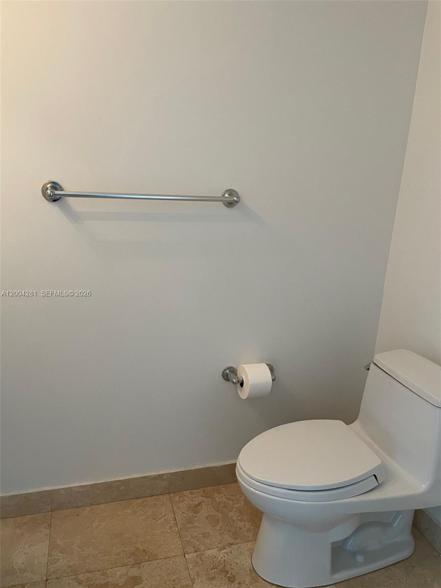 41 Southeast 5th Street, Unit 1614 Miami, FL 33131 - Photo 15 of 23 a white toilet sitting next to a shower