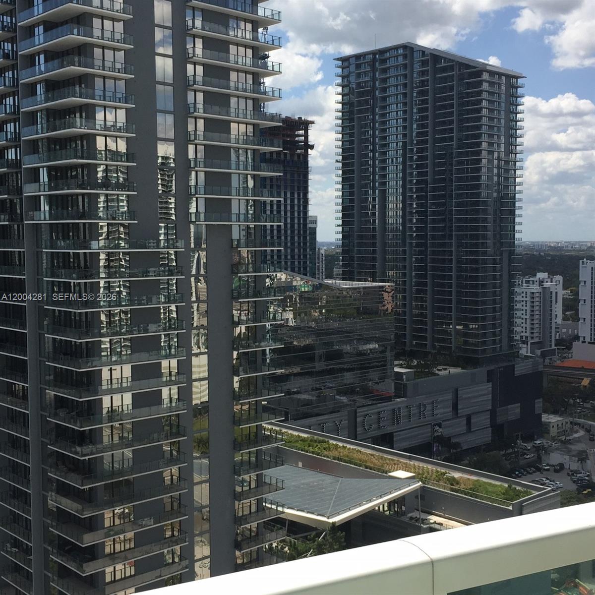 41 Southeast 5th Street, Unit 1614 Miami, FL 33131 - Photo 17 of 23 a view of a balcony with a couple of cars parked in front of door
