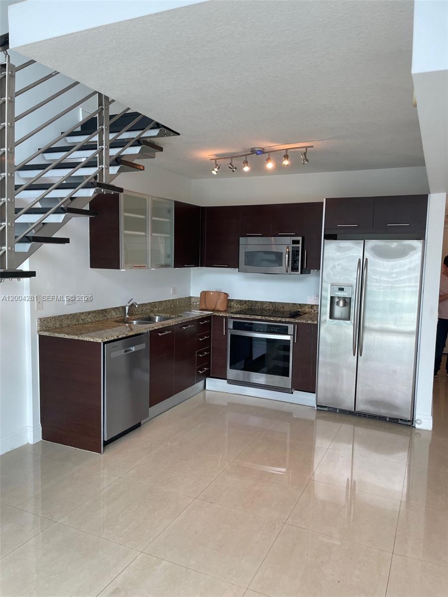 41 Southeast 5th Street, Unit 1614 Miami, FL 33131 - Photo 8 of 23 a large kitchen with a stove and cabinets