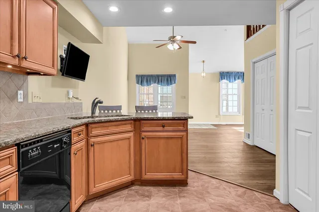 a kitchen with stainless steel appliances granite countertop a stove and a sink