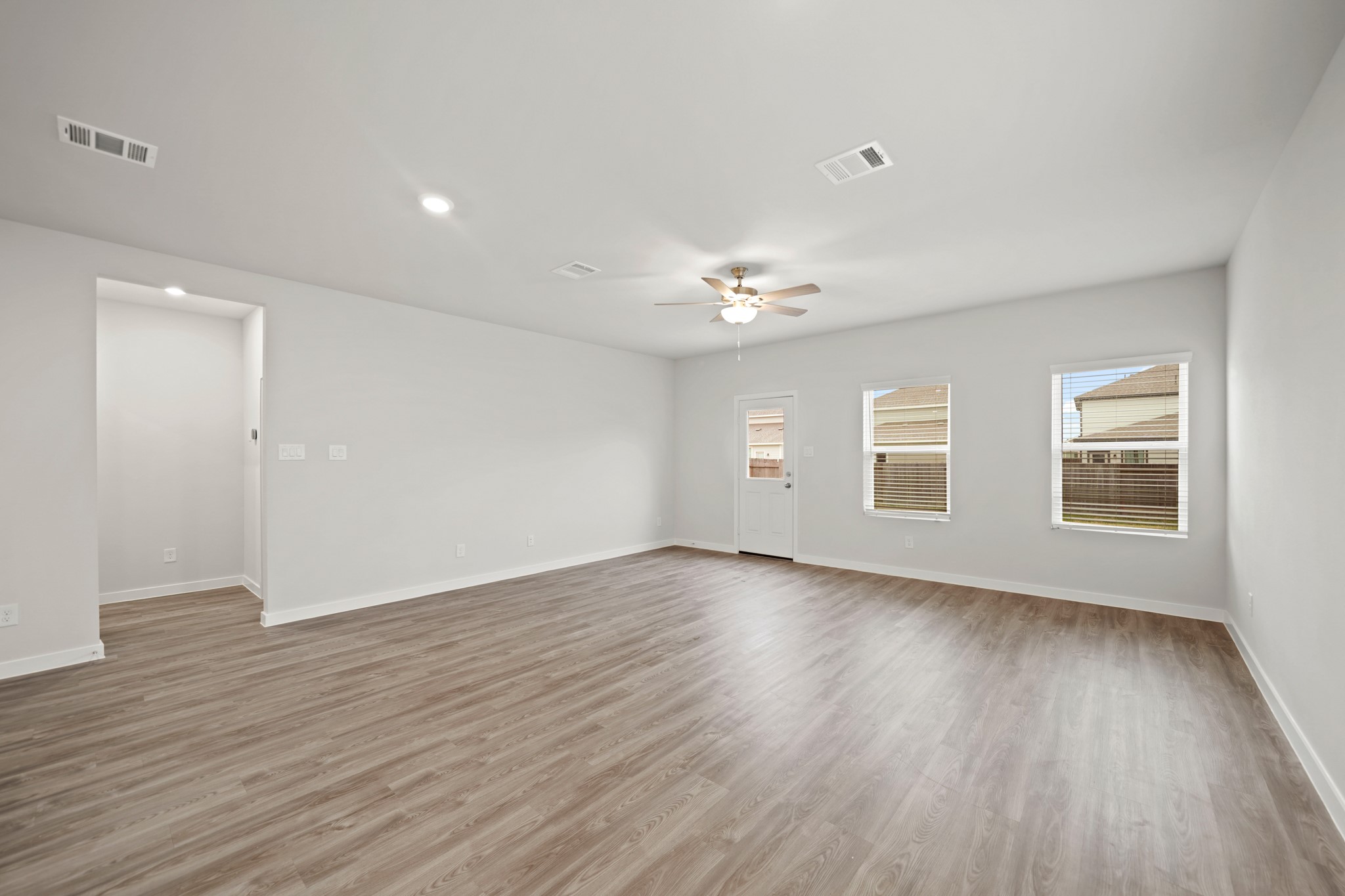 14419 Elmfield Lane Conroe, TX 77303 - Photo 7 of 22 a view of an empty room with wooden floor and window