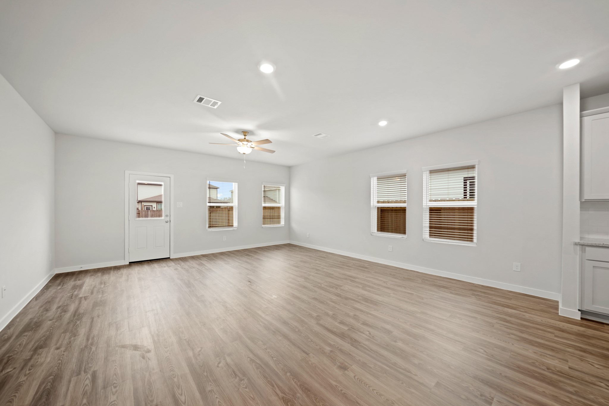 14419 Elmfield Lane Conroe, TX 77303 - Photo 8 of 22 wooden floor in an empty room with a window