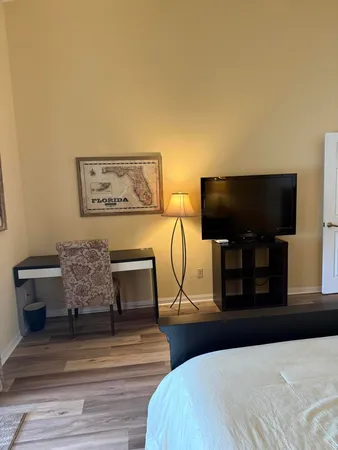 a bedroom with furniture and a flat screen tv