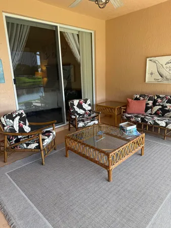 a living room with furniture a flat screen tv and a table