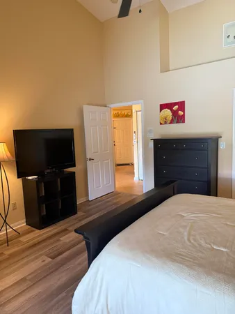 a bedroom with a bed and wooden floor