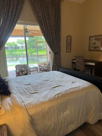 a bedroom with a bed and a large window