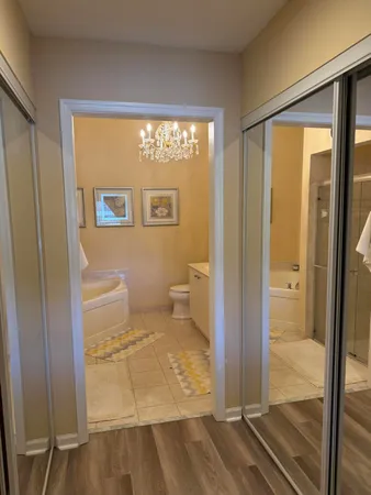 a bathroom with a glass door shower and a toilet