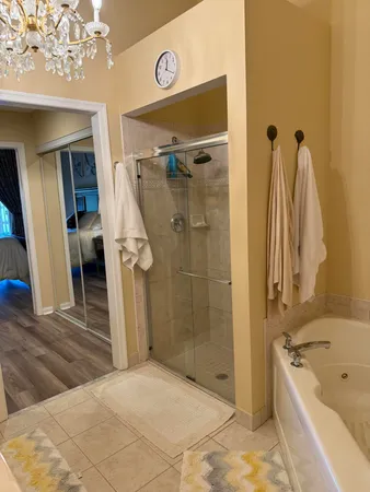 a bathroom with a tub a sink and a mirror