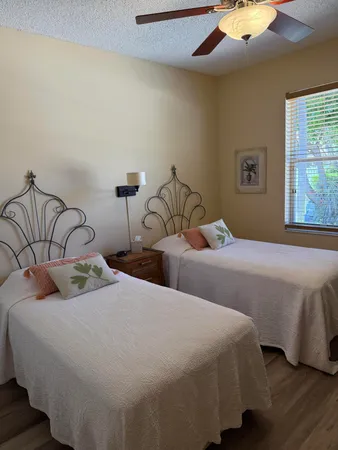 a bedroom with two beds and a night stand