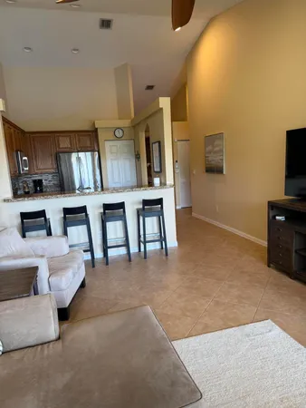 a living room with couches and a flat screen tv