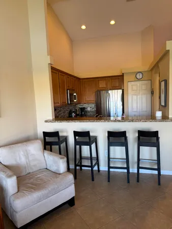 a living room with furniture and kitchen view