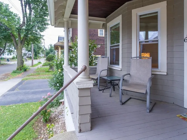 a view of a house with backyard and sitting area