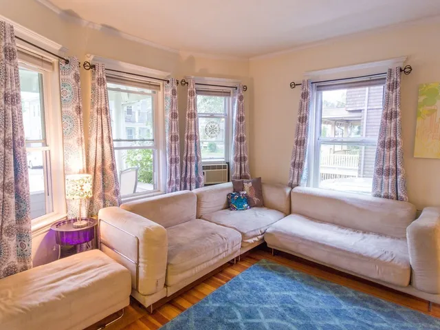 a spacious bedroom with a bed and a couch next to a window