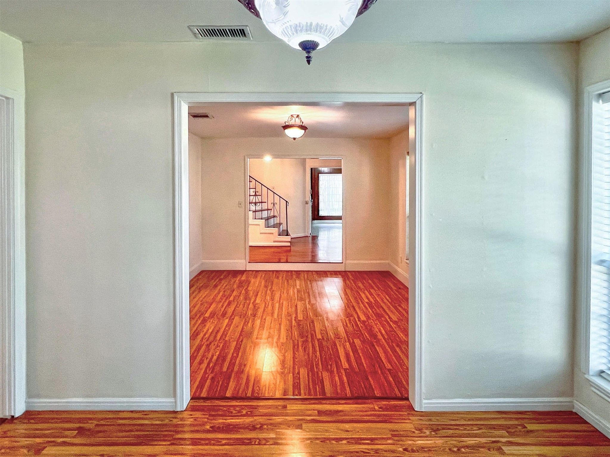 16902 Summit Oaks Lane Spring, TX 77379 - Photo 10 of 49 a view of an empty room with wooden floor and a window