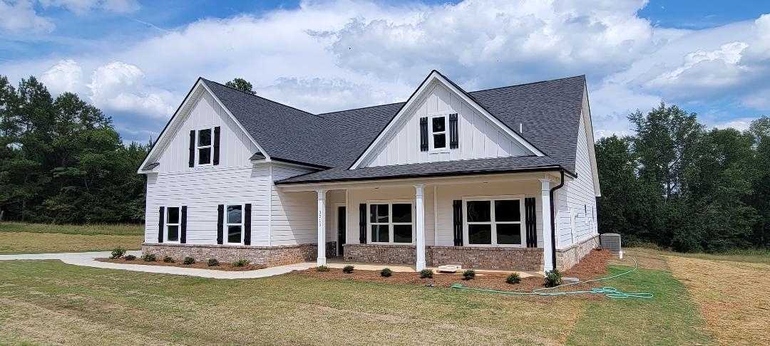 3215 Old Jackson Road, Unit 7 Locust Grove, GA 30248 - Photo 1 of 1 a front view of a house with a yard